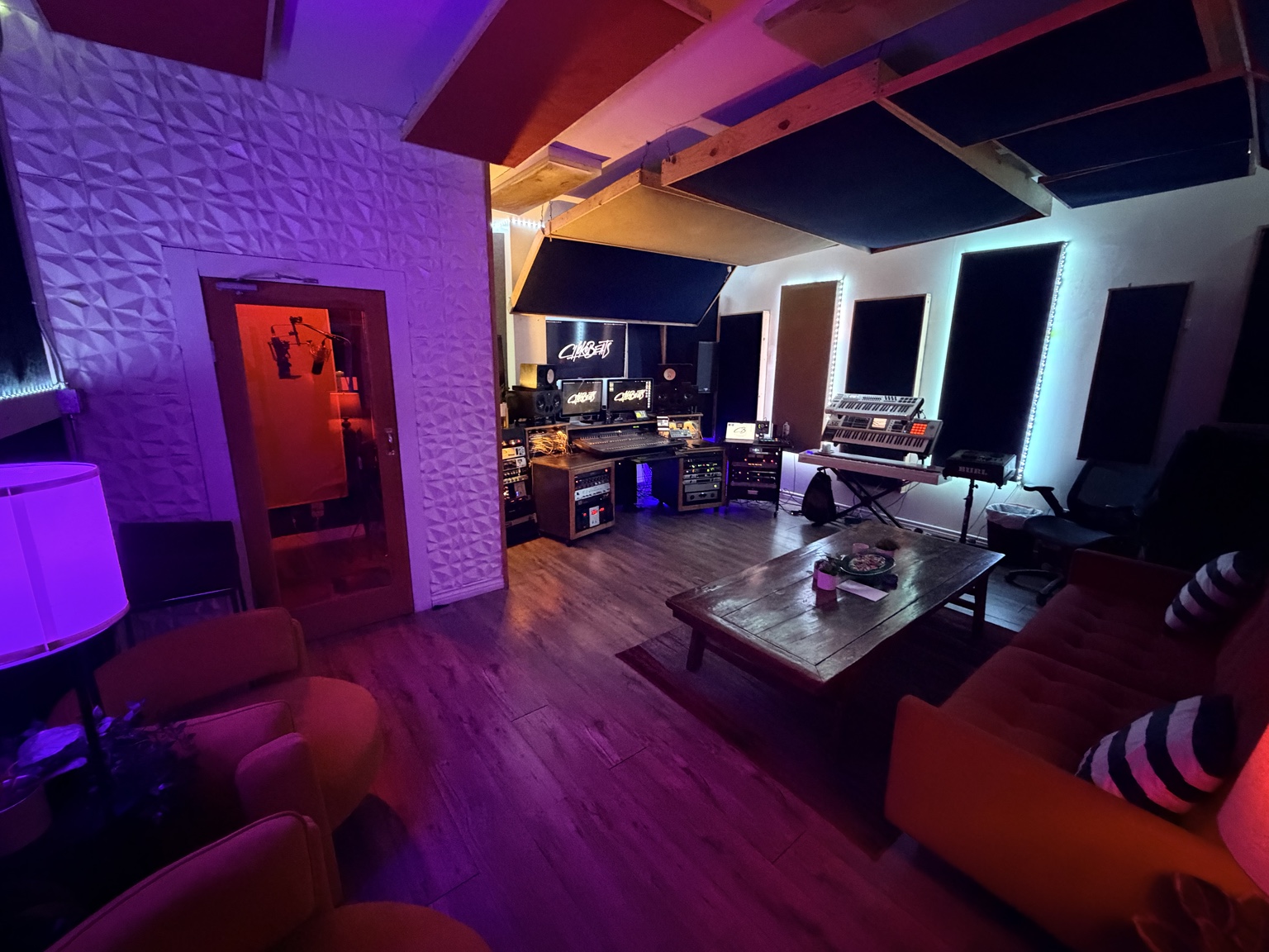 Wide view of the Chokobeats studio, vocal booth, control room, and lounge